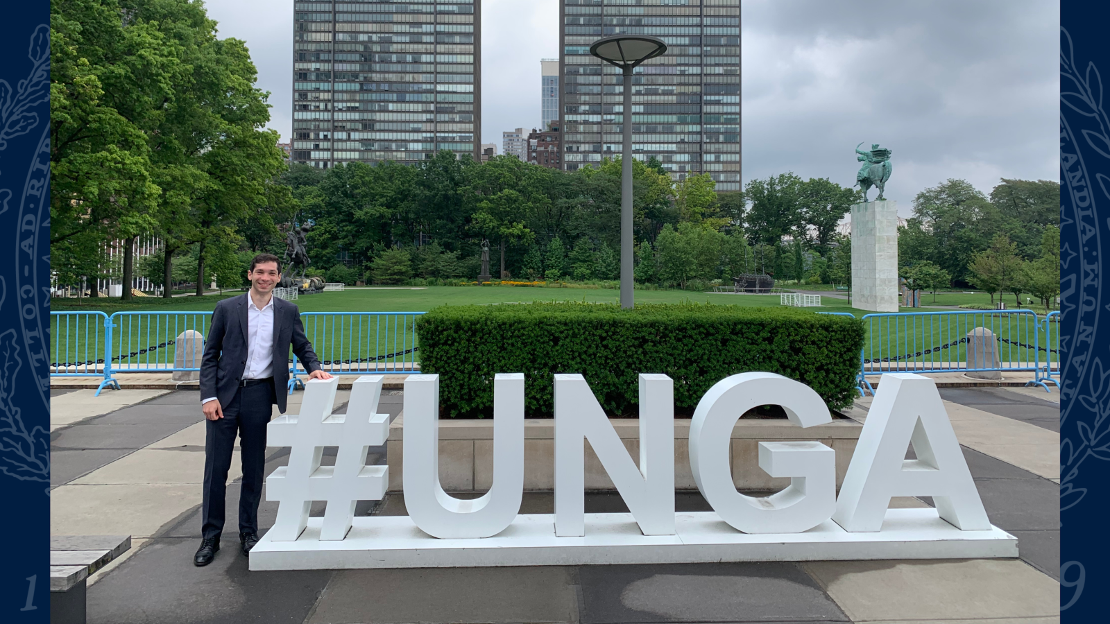 Caleb in front of a white #UNGA at the UN 