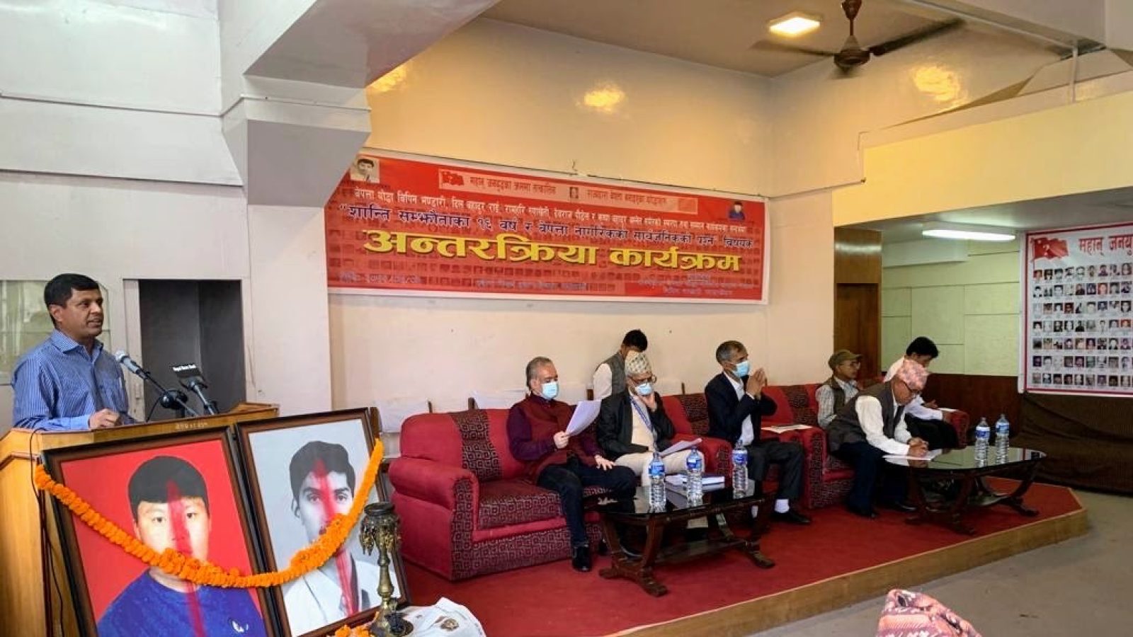 Panelists sit on red couches at a commemoration event in Kathmandu.