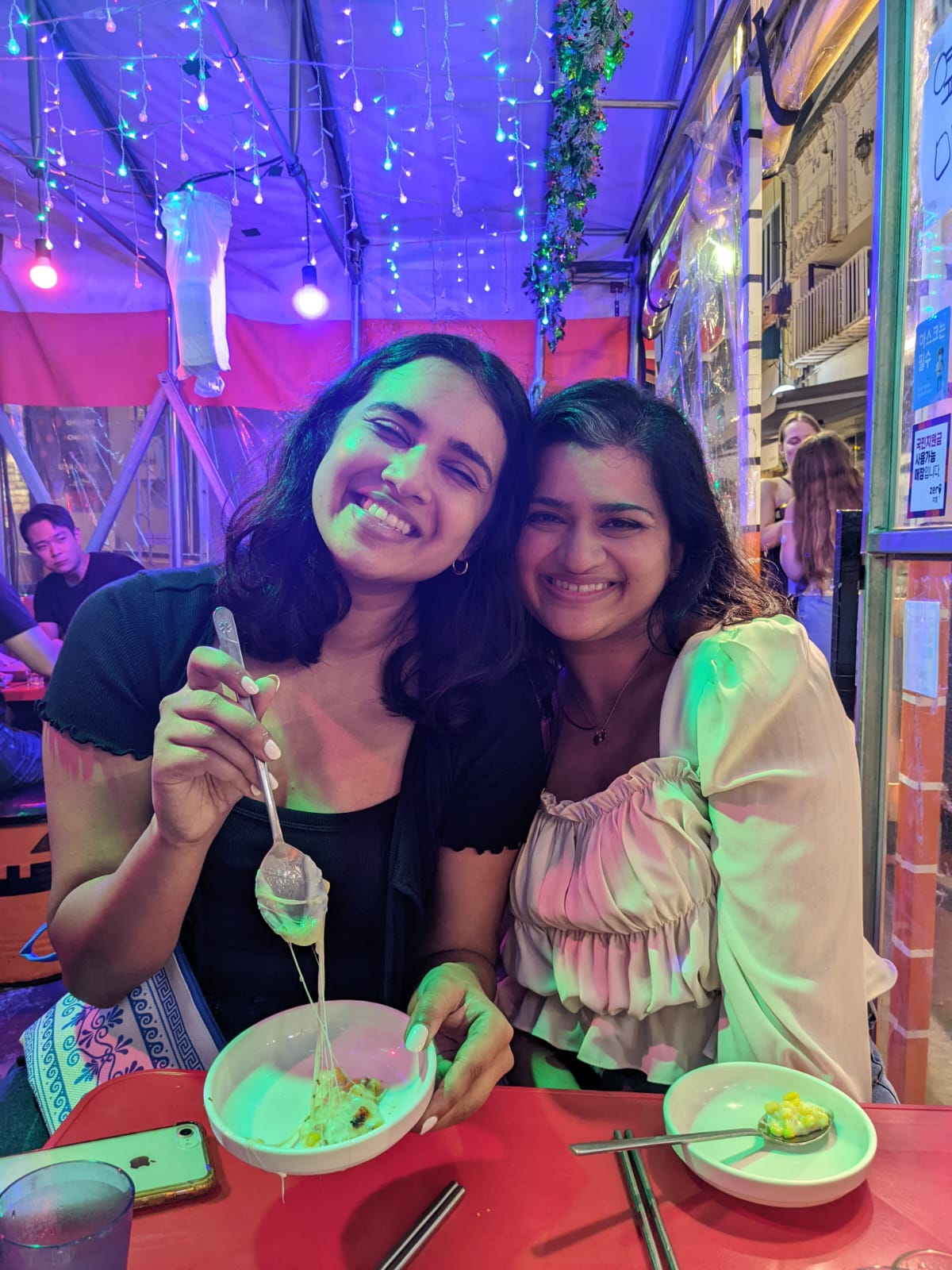 Anaga and Kavya at a cafe eating rice bowls.